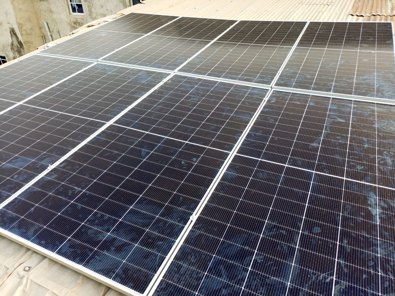 Rooftop solar array with rows of panels mounted on a client roof